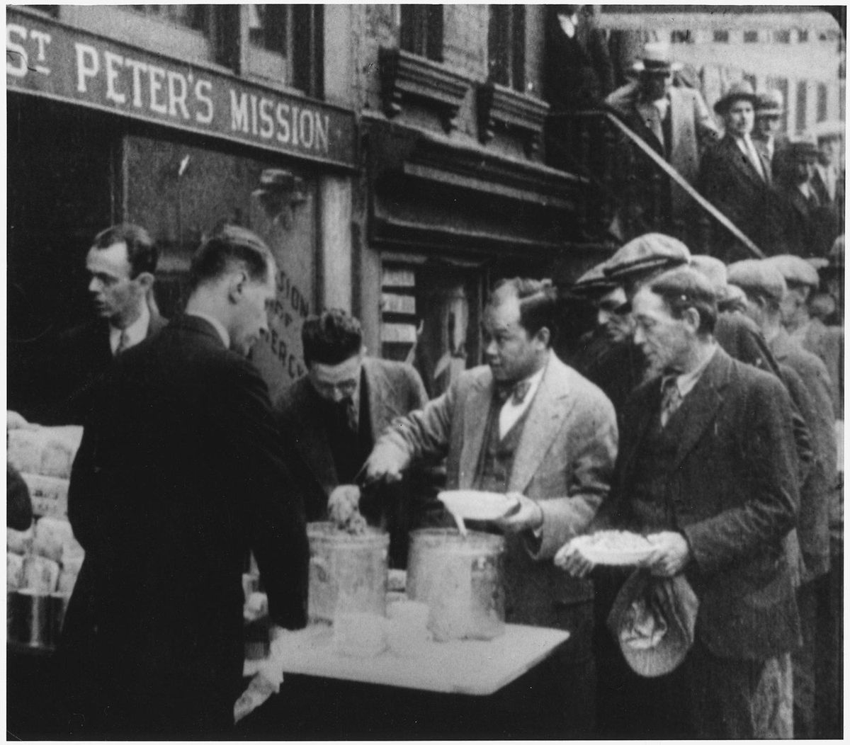 Archival photograph of men receiving food outside a New York City mission, circa 1932.