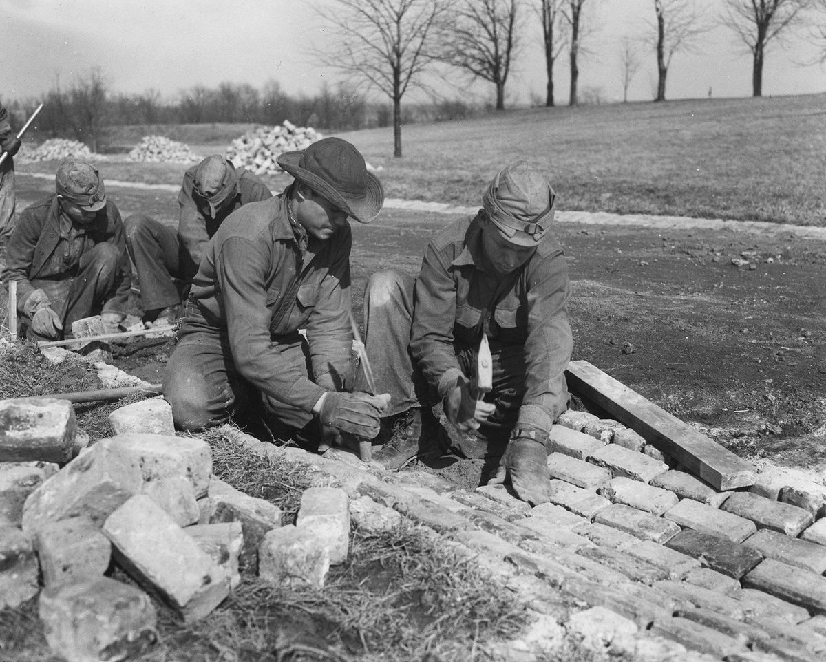Archival photograph of Civilian Conservation Corps workers constructing stonework, circa 1933.
