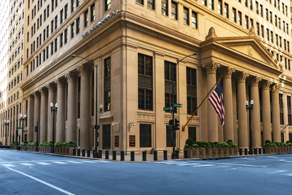 Columned stone facade of the Federal Reserve Bank of Chicago with an American flag