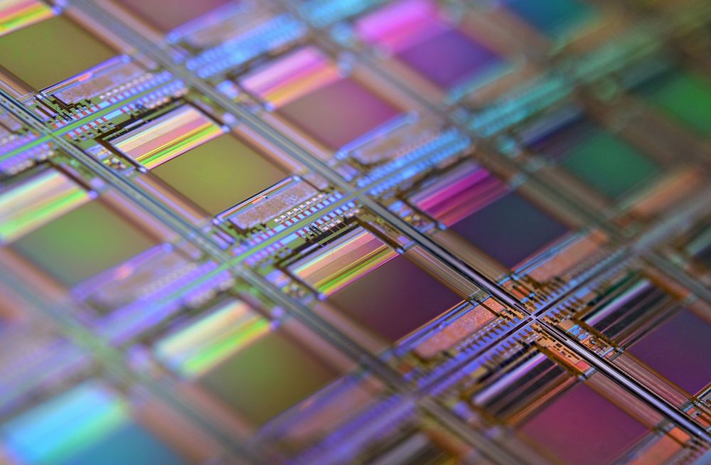 Close-up of a silicon wafer patterned with iridescent microchips