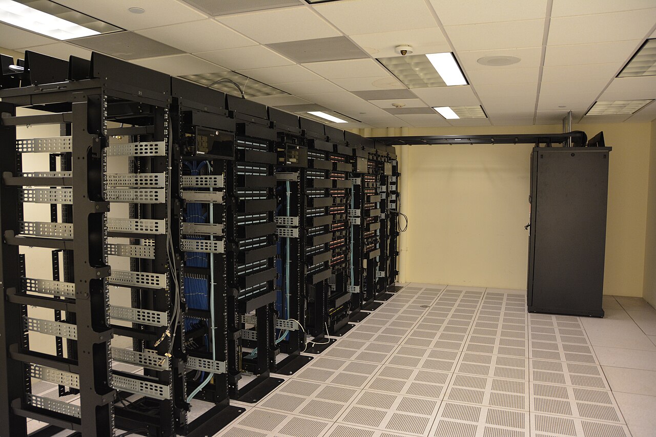 Rows of black server racks in a data center